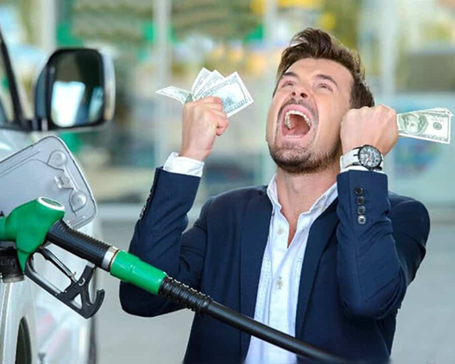 man holding money at gas pump