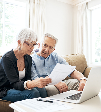 Retired couple reviewing NIHFCU IRA's