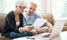 Retired couple reviewing NIHFCU IRA's